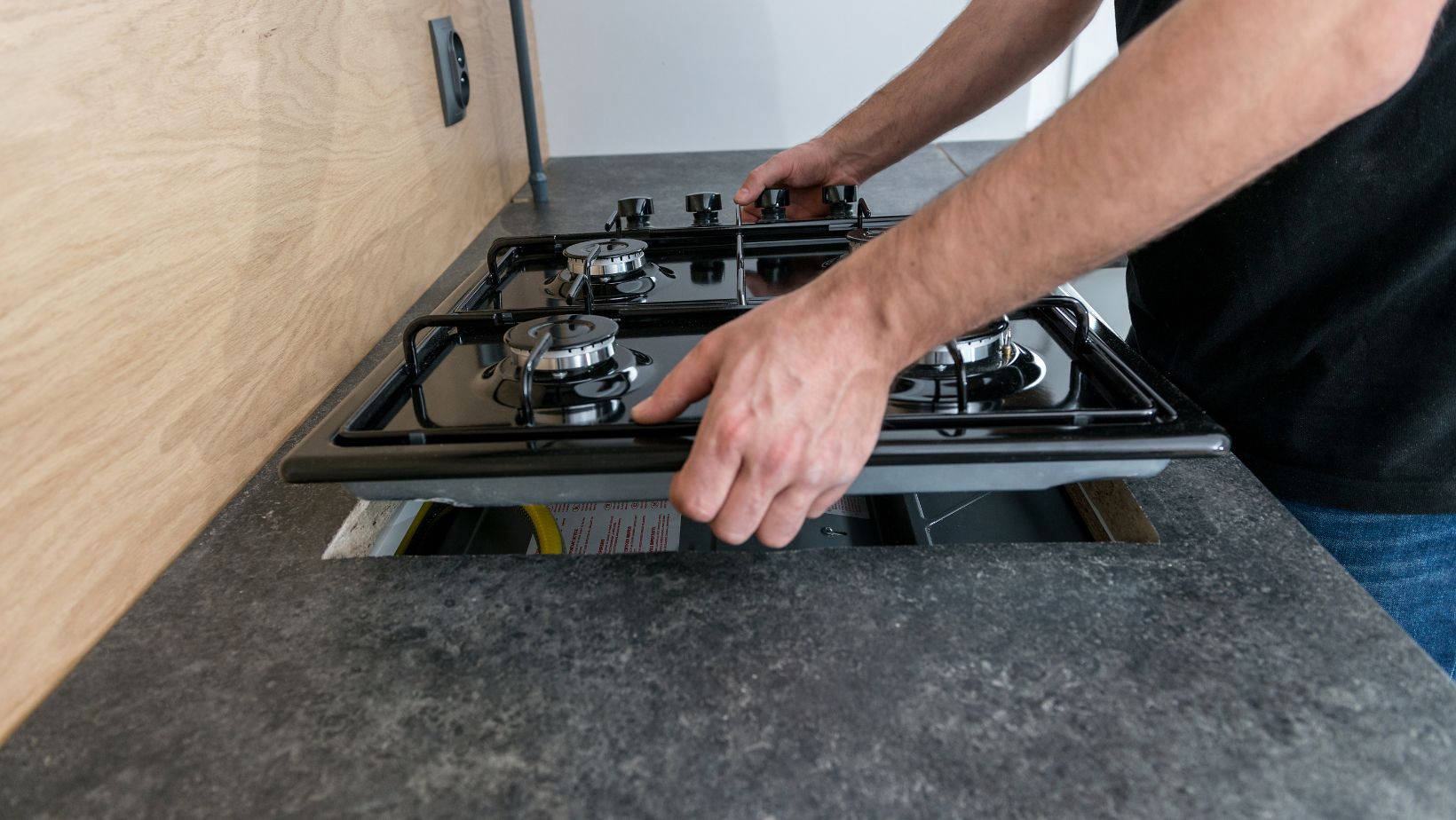 Expert Gas Appliances Installation. Expert gas cooktop installation – professional technician securing a gas stove for safe and efficient use.