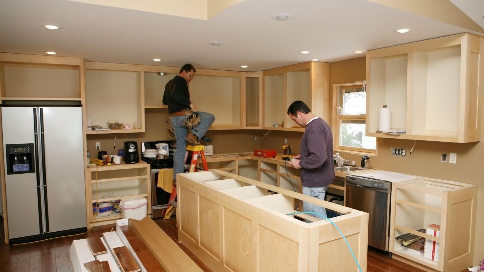 Home remodeling contractors in Birmingham, Alabama – kitchen renovation in progress with new cabinet installation.